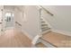 Bright stairway with hardwood treads, white risers, and natural wood handrail leading to upper level at 1413 Collier Walk Aly # Csw0106, Charlotte, NC 28205