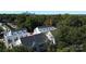 Aerial view of modern townhomes nestled among lush trees with the city skyline in the distance at 1211 E 34Th St # Csw0313, Charlotte, NC 28205