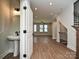 Stylish powder room with pedestal sink next to the staircase with hardwood floors at 1211 E 34Th St # Csw0313, Charlotte, NC 28205