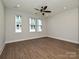 Open living room with hardwood floors, ceiling fan, and recessed lighting at 1211 E 34Th St # Csw0313, Charlotte, NC 28205