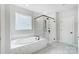 Luxurious bathroom with a soaking tub, tiled shower, and marble flooring at 2003 Cedar Falls Dr # 69, Waxhaw, NC 28173