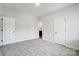 Bright, airy bedroom features neutral walls, plush carpeting, and two closet doors at 2003 Cedar Falls Dr # 69, Waxhaw, NC 28173