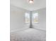 Bright bedroom with plush carpeting, neutral walls, and two large windows at 2003 Cedar Falls Dr # 69, Waxhaw, NC 28173