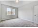 The carpeted bedroom features a large window, neutral paint, and ample space for relaxation and rest at 2003 Cedar Falls Dr # 69, Waxhaw, NC 28173