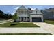 Charming two-story home with a well-maintained lawn, a covered porch, and an attached garage at 2003 Cedar Falls Dr # 69, Waxhaw, NC 28173