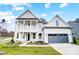 Striking new construction two-story home with a welcoming front porch and two-car garage at 2003 Cedar Falls Dr # 69, Waxhaw, NC 28173