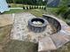 Custom stone fire pit and seating area in a backyard, creating a cozy and inviting outdoor space at 2003 Cedar Falls Dr # 69, Waxhaw, NC 28173