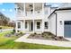 Inviting front porch with white columns, railing and manicured landscaping at 2003 Cedar Falls Dr # 69, Waxhaw, NC 28173
