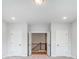 Hallway featuring stairs, two doors, and neutral paint at 2003 Cedar Falls Dr # 69, Waxhaw, NC 28173