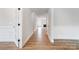 Bright hallway with hardwood floors and decorative wainscoting, leading to a cozy living area at 2003 Cedar Falls Dr # 69, Waxhaw, NC 28173