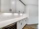 Bright kitchen features a beverage fridge, white cabinets, countertop space and an attractive backsplash at 2003 Cedar Falls Dr # 69, Waxhaw, NC 28173