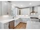Bright kitchen features white cabinets, stainless steel appliances, and a farmhouse sink beneath a window at 2003 Cedar Falls Dr # 69, Waxhaw, NC 28173