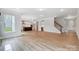 Expansive living area with fireplace, open kitchen, and a staircase to the upper level at 2003 Cedar Falls Dr # 69, Waxhaw, NC 28173
