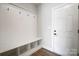 A bright mudroom with built-in bench, coat hooks, and storage cubbies, creating an organized entryway at 2003 Cedar Falls Dr # 69, Waxhaw, NC 28173