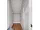 A small storage space with a white shelf and wooden flooring, ideal for organization and accessibility at 2003 Cedar Falls Dr # 69, Waxhaw, NC 28173