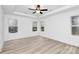 Bright bedroom with wood-look floors and three windows at 6100 Lowder Rd, Salisbury, NC 28147