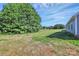 Expansive backyard features lush green grass and mature trees, perfect for outdoor activities at 6122 Lowder Rd, Salisbury, NC 28147