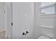 Bathroom with a white toilet and modern accessories, including a sleek towel rack and updated wall hardware at 6122 Lowder Rd, Salisbury, NC 28147