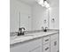 Bright bathroom with double sinks, granite countertops, black fixtures, decorative lighting, and a large frameless mirror at 6122 Lowder Rd, Salisbury, NC 28147