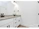 Bathroom with double sinks, granite countertop, white cabinets and wood-style flooring at 6122 Lowder Rd, Salisbury, NC 28147