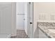 Well-lit bathroom features sleek gray floors, granite counters, modern fixtures, and a shower with a white shower surround at 6122 Lowder Rd, Salisbury, NC 28147