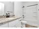 A bathroom featuring a granite countertop vanity and a shower/tub combo with white tiling at 6122 Lowder Rd, Salisbury, NC 28147