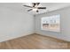 Bright bedroom with light wood floors, large window, and ceiling fan at 6122 Lowder Rd, Salisbury, NC 28147