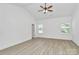 A bedroom featuring wood-look flooring, neutral walls, a ceiling fan, and two windows providing natural light at 6122 Lowder Rd, Salisbury, NC 28147