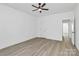 Spacious bedroom with a ceiling fan, light hardwood floors, and a hallway at 6122 Lowder Rd, Salisbury, NC 28147