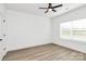 A bedroom featuring wood-look flooring, neutral walls, a ceiling fan, and one window providing natural light at 6122 Lowder Rd, Salisbury, NC 28147