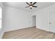Bright bedroom featuring a ceiling fan, light hardwood floors, and white walls and trim at 6122 Lowder Rd, Salisbury, NC 28147