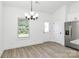 Bright dining area featuring a modern chandelier fixture, natural light, and entry to the back of the property at 6122 Lowder Rd, Salisbury, NC 28147