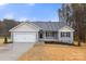 Charming single-story home with attached garage, gray siding, and a well-manicured lawn on a sunny day at 6122 Lowder Rd, Salisbury, NC 28147
