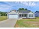 Charming single-story home with a two-car garage, blue siding and a well-manicured lawn on a sunny day at 6122 Lowder Rd, Salisbury, NC 28147
