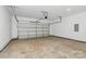 Spacious two car garage including garage door opener, bare concrete floor, and white walls at 6122 Lowder Rd, Salisbury, NC 28147