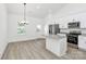 The modern, open kitchen and dining area has an island, stainless appliances, and lots of bright, natural light at 6122 Lowder Rd, Salisbury, NC 28147