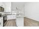 Bright kitchen with stainless steel appliances, granite countertops, a central island, white cabinets, and hardwood floors at 6122 Lowder Rd, Salisbury, NC 28147