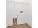 A new laundry room with shelf, outlet, and water hookups and hardwood floors at 6122 Lowder Rd, Salisbury, NC 28147