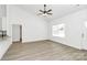 Well-lit open concept living room featuring wood floors, white walls, and seamless transition to the modern kitchen at 6122 Lowder Rd, Salisbury, NC 28147