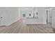 Open concept living room view features neutral paint colors, luxury vinyl flooring, and seamless access to kitchen at 6122 Lowder Rd, Salisbury, NC 28147
