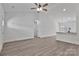 Spacious living room features a ceiling fan and light neutral paint to accent the luxury vinyl flooring throughout at 6122 Lowder Rd, Salisbury, NC 28147