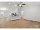 Spacious living room flows into the kitchen, featuring an island and modern lighting fixtures at 6122 Lowder Rd, Salisbury, NC 28147