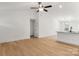 Bright living area with wood flooring flowing into an open kitchen with granite countertops and white cabinets at 6122 Lowder Rd, Salisbury, NC 28147