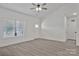 Bright living room features a ceiling fan, luxury vinyl flooring, and lots of natural light through the window at 6122 Lowder Rd, Salisbury, NC 28147
