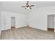 A spacious main bedroom featuring wood-look flooring, neutral walls, a ceiling fan, and a walk-in closet at 6122 Lowder Rd, Salisbury, NC 28147