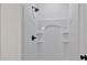 Bathroom shower features white shower surround, black hardware, built-in shelves, and modern plumbing fixtures at 6122 Lowder Rd, Salisbury, NC 28147