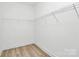 A walk-in closet is equipped with wire shelving and wood-look flooring at 6122 Lowder Rd, Salisbury, NC 28147