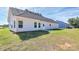 View of the side and back of the home with a well-maintained lawn and a side view of a light blue home at 6154 Lowder Rd, Salisbury, NC 28147