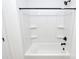 Clean white bathroom with tub and shower featuring shelves at 6154 Lowder Rd, Salisbury, NC 28147