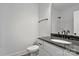 A view of the toilet, sink, vanity, mirror and lighting in this bathroom at 6154 Lowder Rd, Salisbury, NC 28147